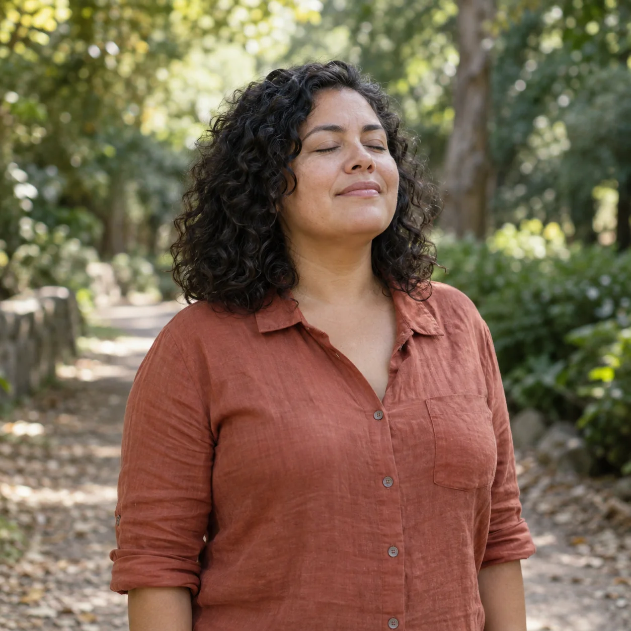 Woman pausing for a calm breath on a leafy park path